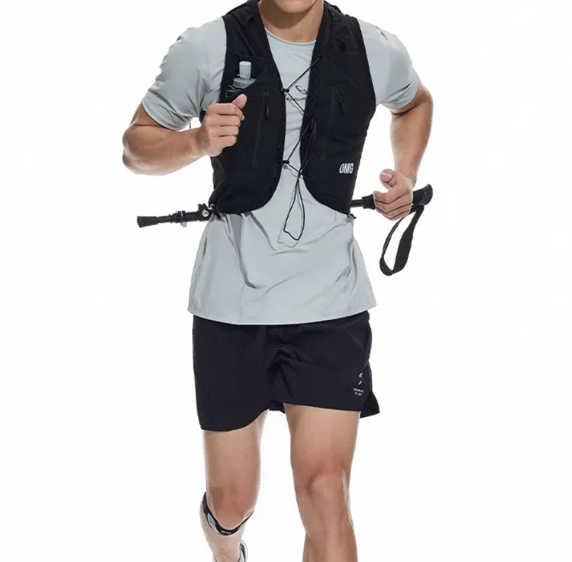 Black running shorts with laser stitching detail on a grey background.