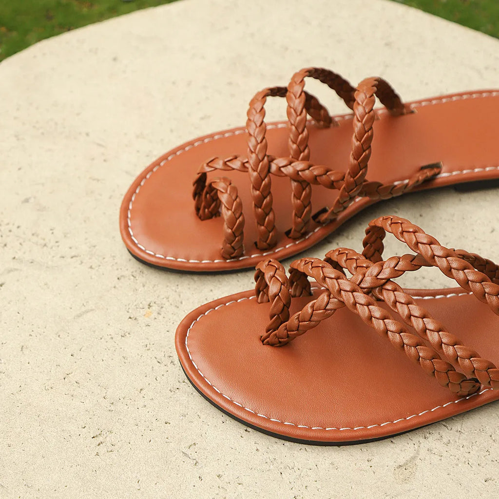 Women's brown clip-toe woven flat sandals on a light background