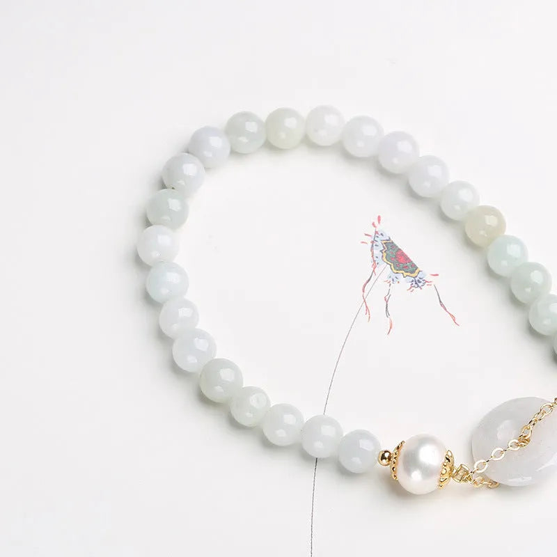 Women's jade bracelet with emerald peace buckle and pearl details in geometric national style design