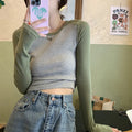 Dark blue oversized women's casual top with long princess sleeves and embroidery detail on a hanger.