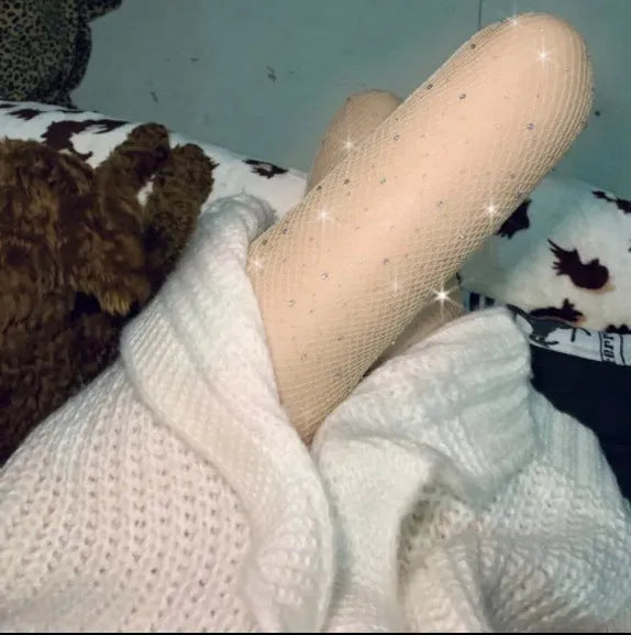 Diamond pattern mesh fishnet stockings in skin colour on a leg.