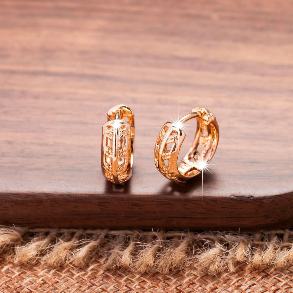 Rose gold plated copper earrings with hollowed-out leaf and heart shapes creating intricate cut-out patterns