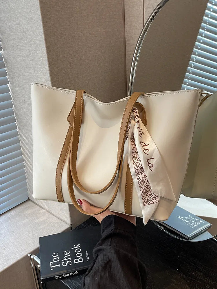 Women's large capacity soft tote bag in multiple colour options showing bucket design and crossbody strap