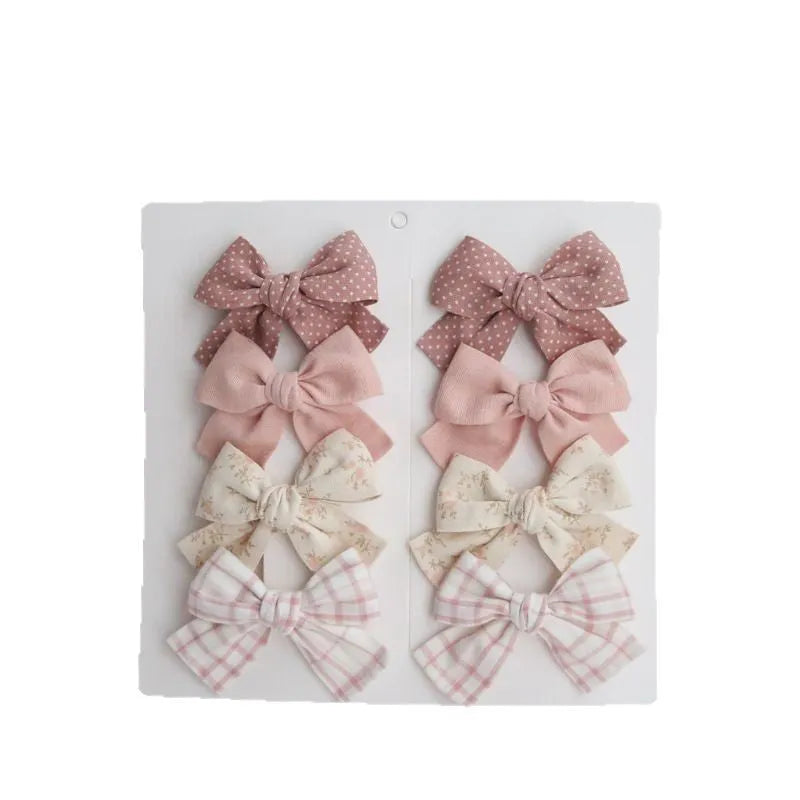 Children's cloth hairclips with dovetail bow design in beige brown grid dots pattern