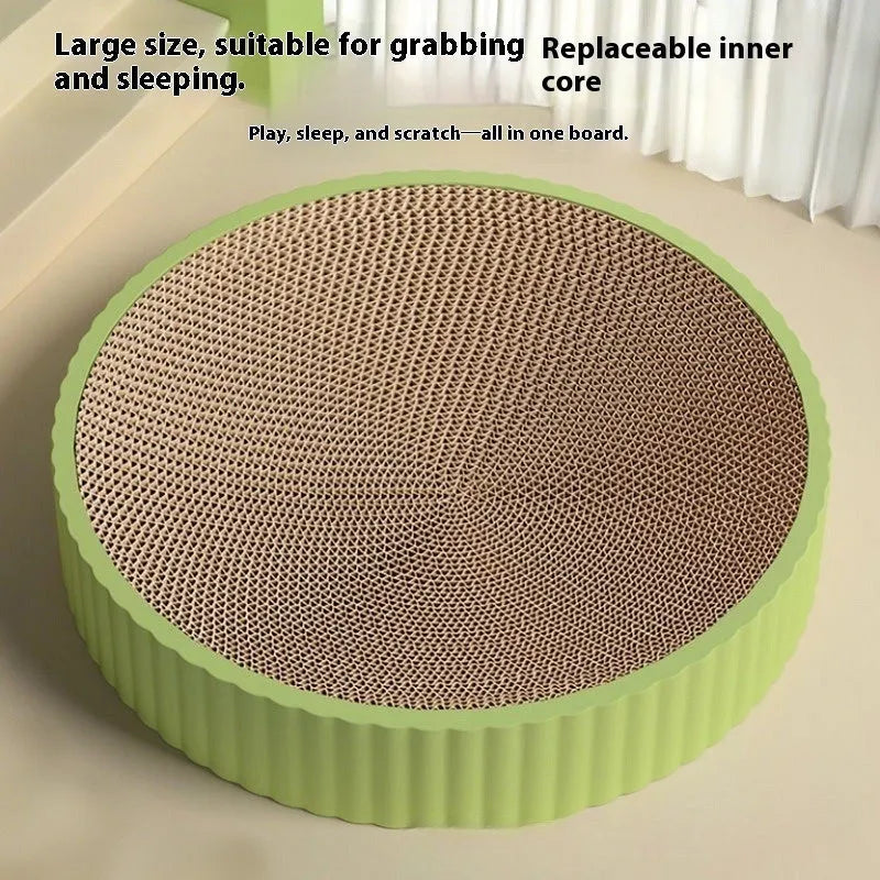 Round green and white cat scratching board nest measuring 55cm with corrugated paper surface.