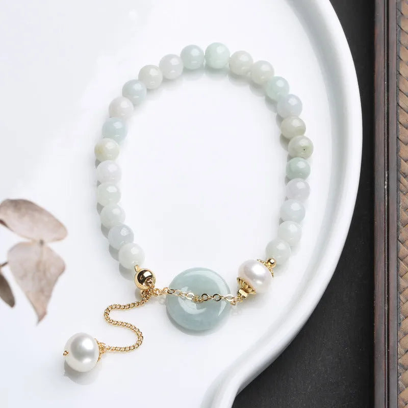 Women's jade bracelet with emerald peace buckle and pearl details in geometric national style design