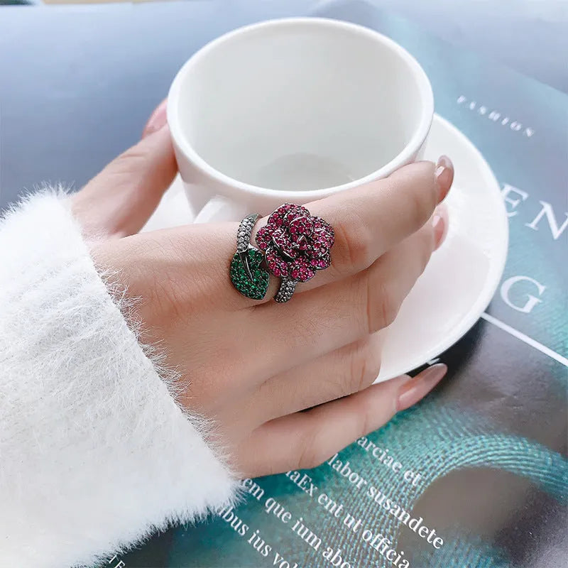 Black gold geometric flower ring with red simulation stones on gold-plated copper band