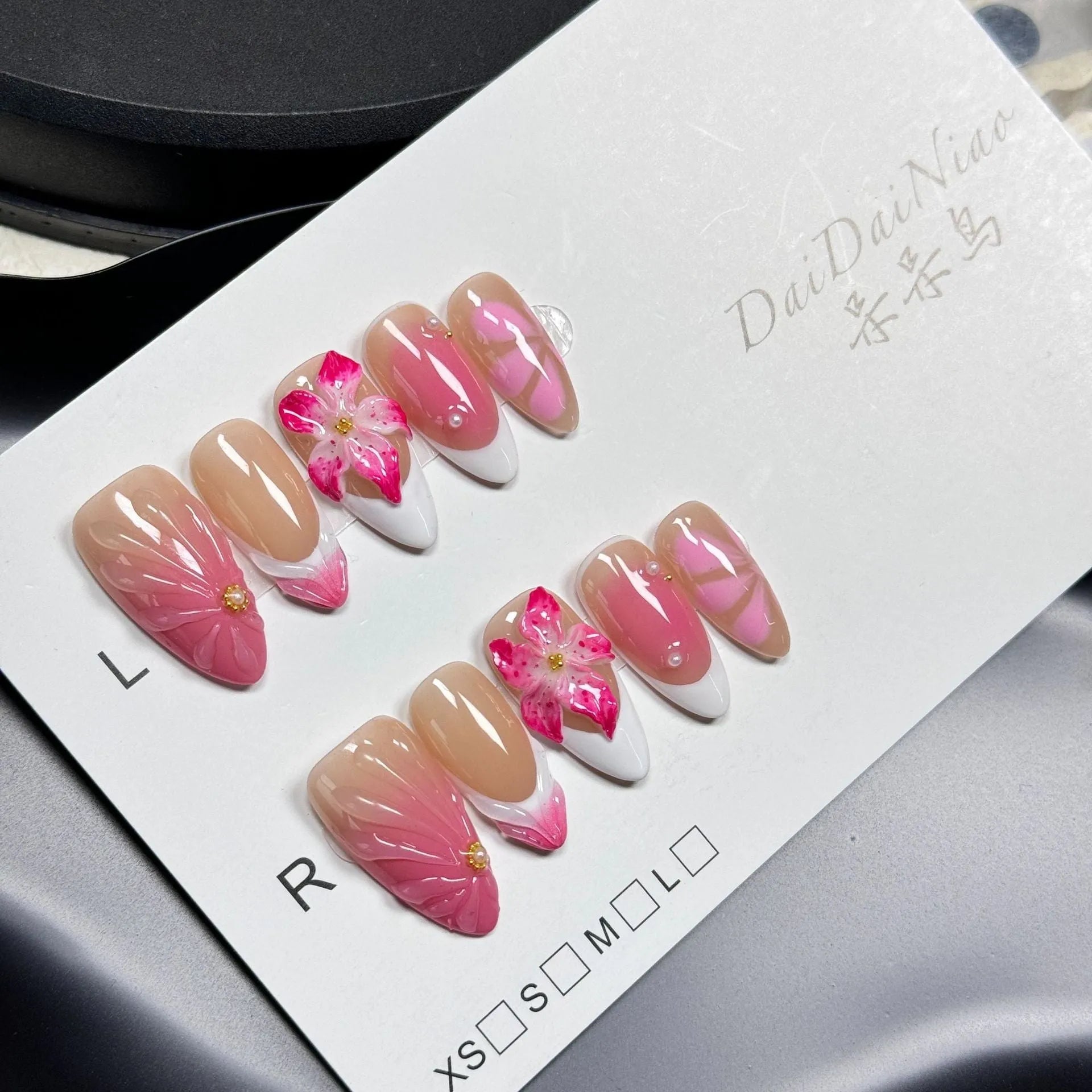 French style Lily Fluid Ice Flower design 3D artificial press-on nails in almond shape, showing colour mix and size scale.