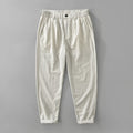 Men's loose straight cotton linen pants in raw jute colour, mid rise, zipper fly, side view on model
