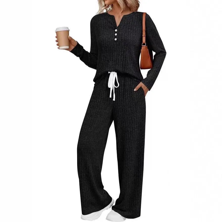 Women's knitted long coat and trouser set in a stripe pattern with V-neck and lace-up detail.