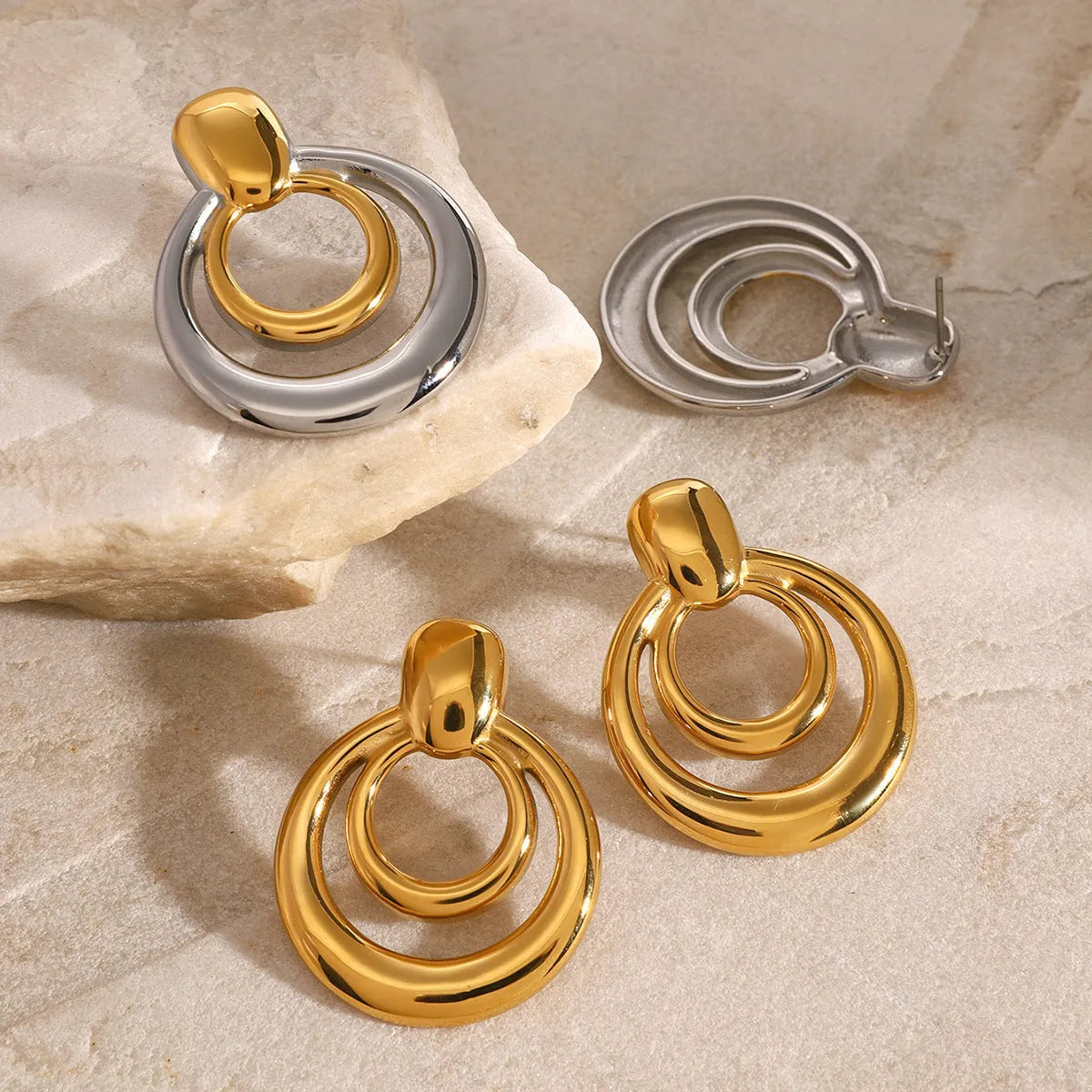 Golden double layer hollow stud earrings with geometric round shape and 18K gold electroplated finish