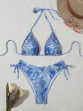 Women's denim blue printed bikini set with strap design, shown as a two-piece swimsuit.