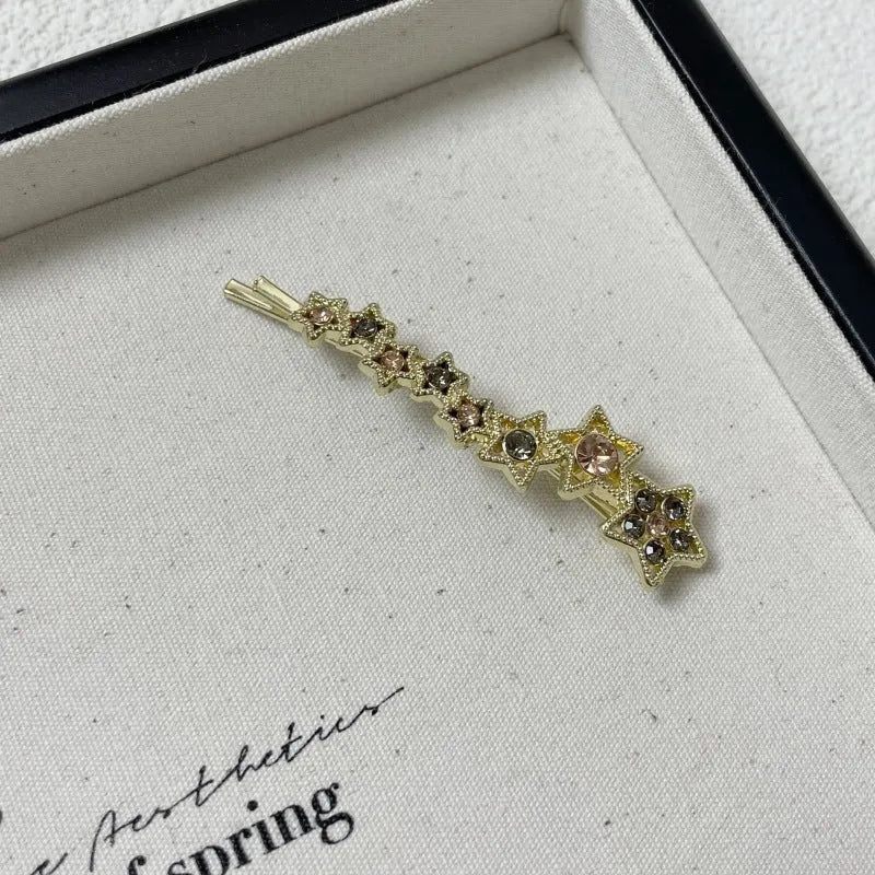 Gold electroplated alloy barrette clip with five-pointed star rhinestone design for bangs and hair sections