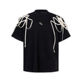 Black loose fit short-sleeve T-shirt with padded shoulders and decorative rivet ribbons.