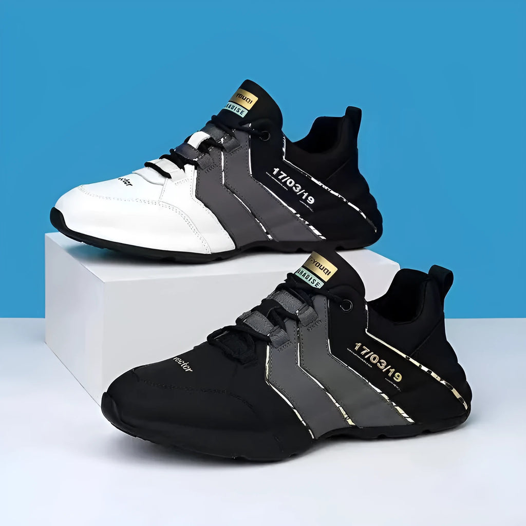 Casual low-top sneakers with round toe, lace-up front, and thick plastic sole in black and grey.