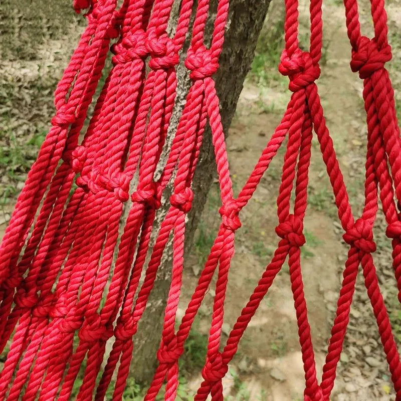 Nylon rope mesh hammock hanging between trees with bold weave pattern, showing 1.1m width