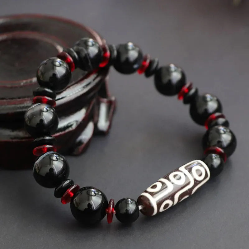 Black agate Dzi bead bracelet with geometric design and hand-woven construction