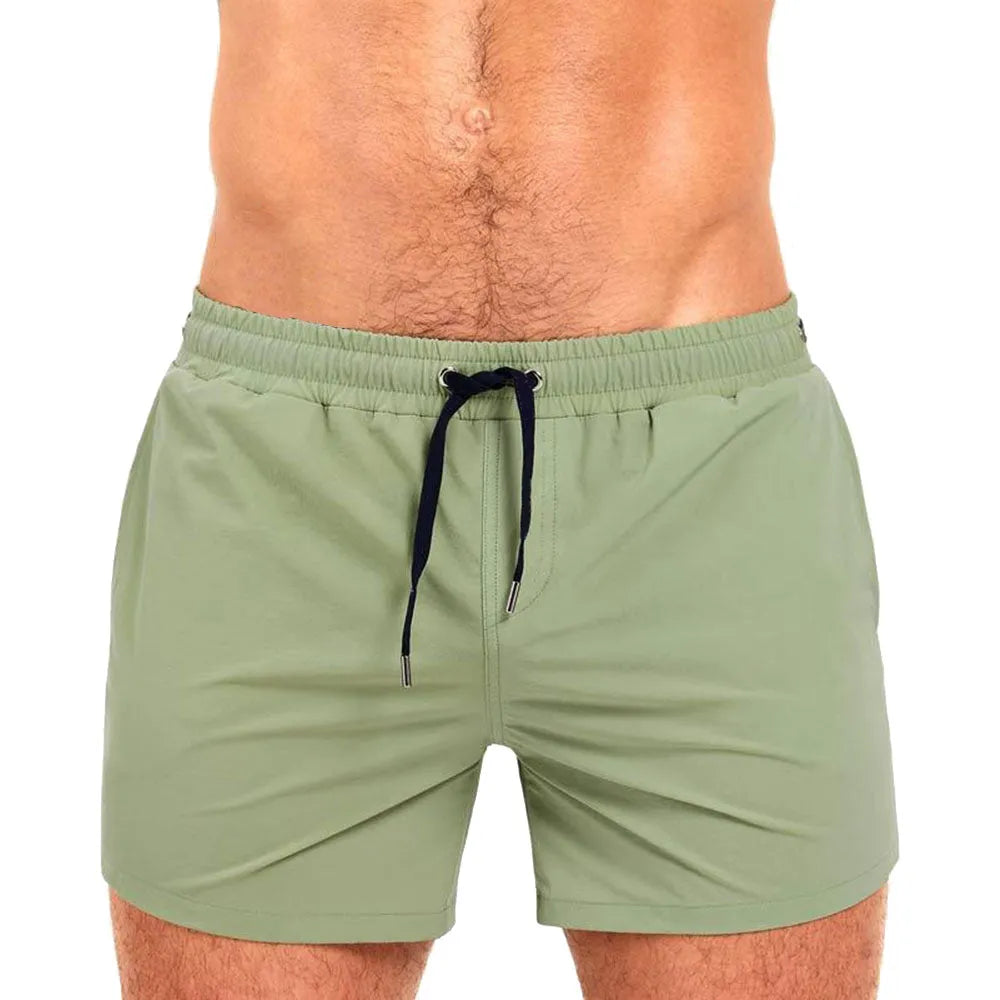 Polyester sports shorts with mesh lining in Army Green colour, laid flat.