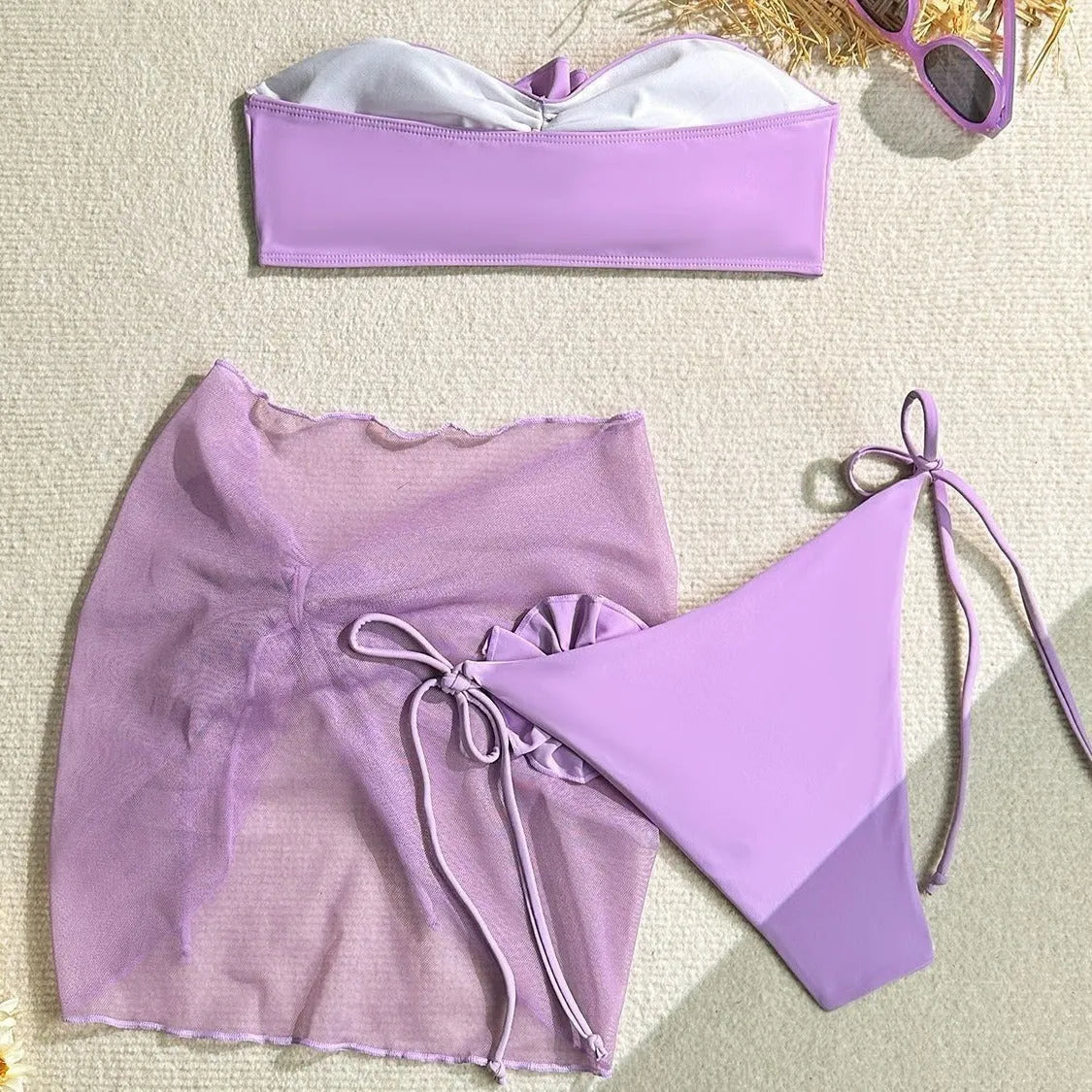 Women's pink tube top swimsuit with large 3D flower tie, matching skirt and bottom.