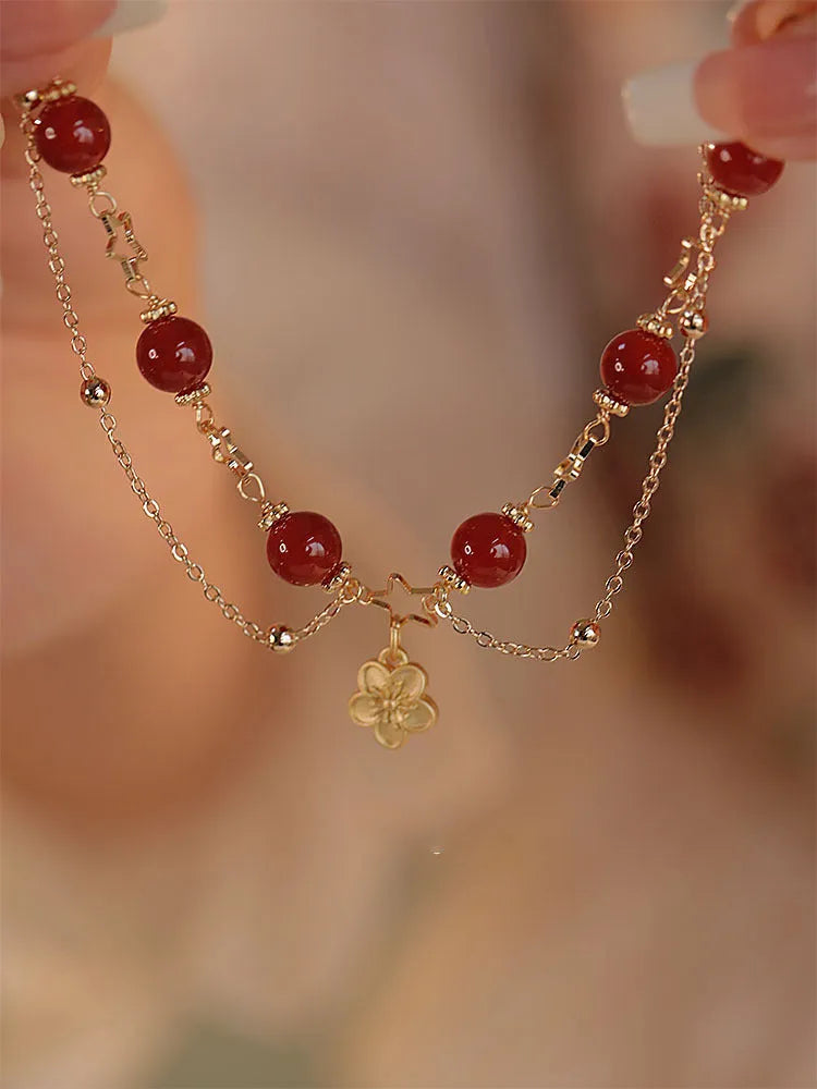 Red agate double layer bracelet with peach blossom decoration on female wrist