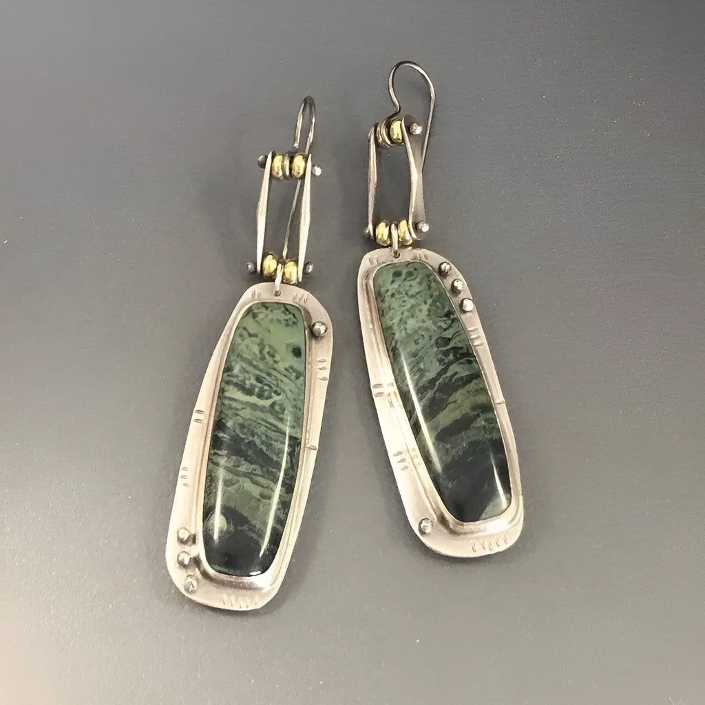 Simple geometric alloy earrings with a two-colour marble pattern and stainless steel posts.