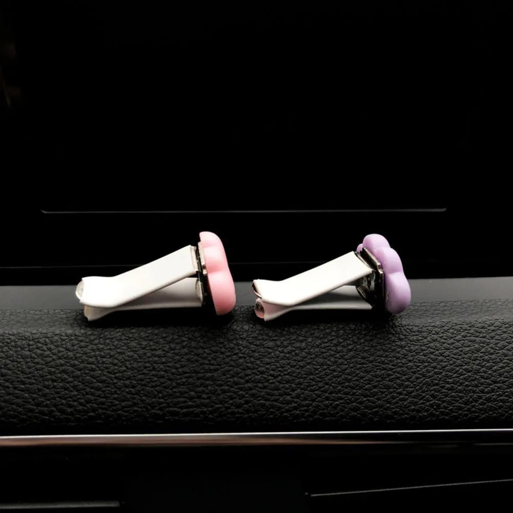 Resin Baiyun cartoon car fragrance clip in light green colour attached to car air vent