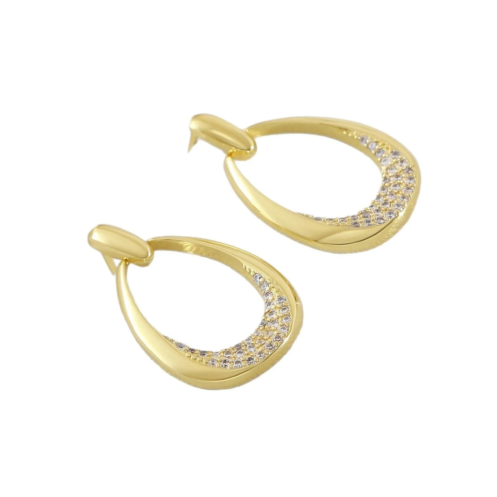 Women's yellow gold geometric drop earrings with simple zircon detail showing oval and round design elements
