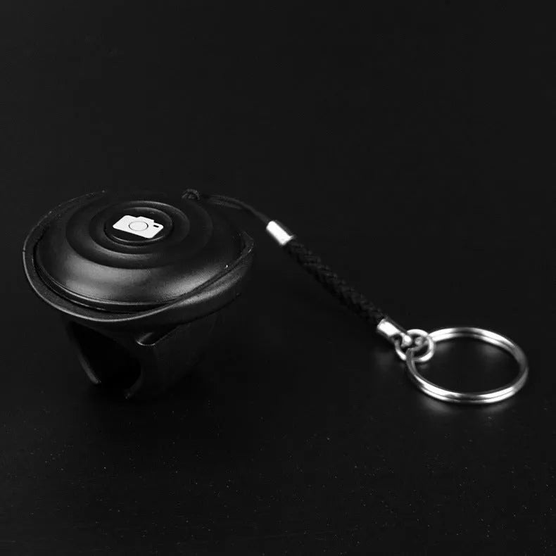 Black Bluetooth selfie remote control with snap attachment for smartphone photography