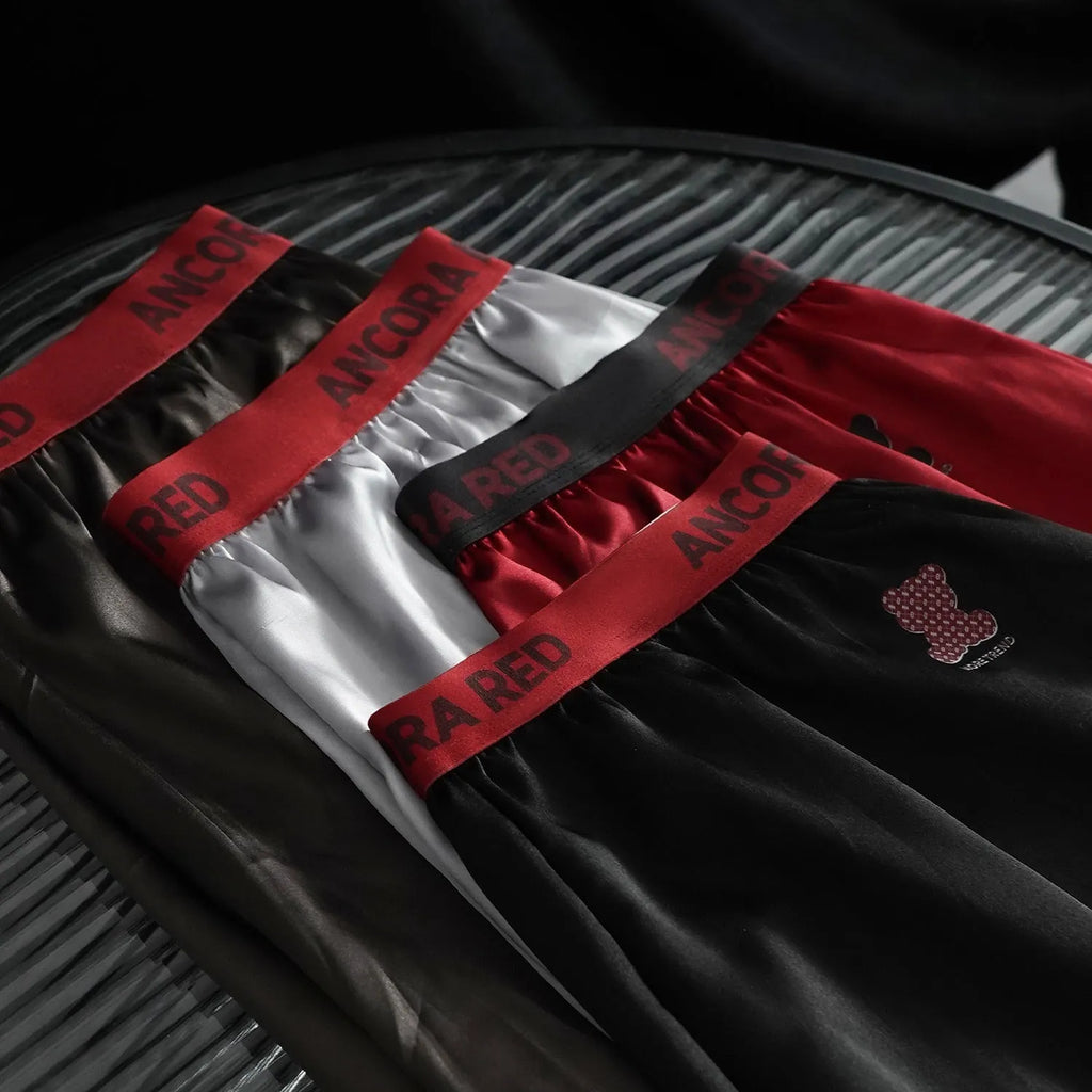 Men's solid colour boxer briefs in black, blue, red, silver, purple and brown showing mid-waist design