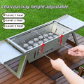 Small portable charcoal grill with folding metal frame for outdoor cooking