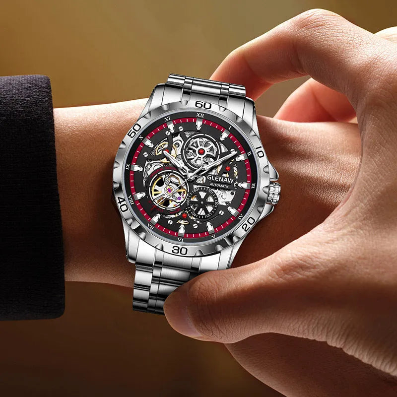 Silver automatic skeleton watch with stainless steel strap and transparent caseback showing mechanical movement