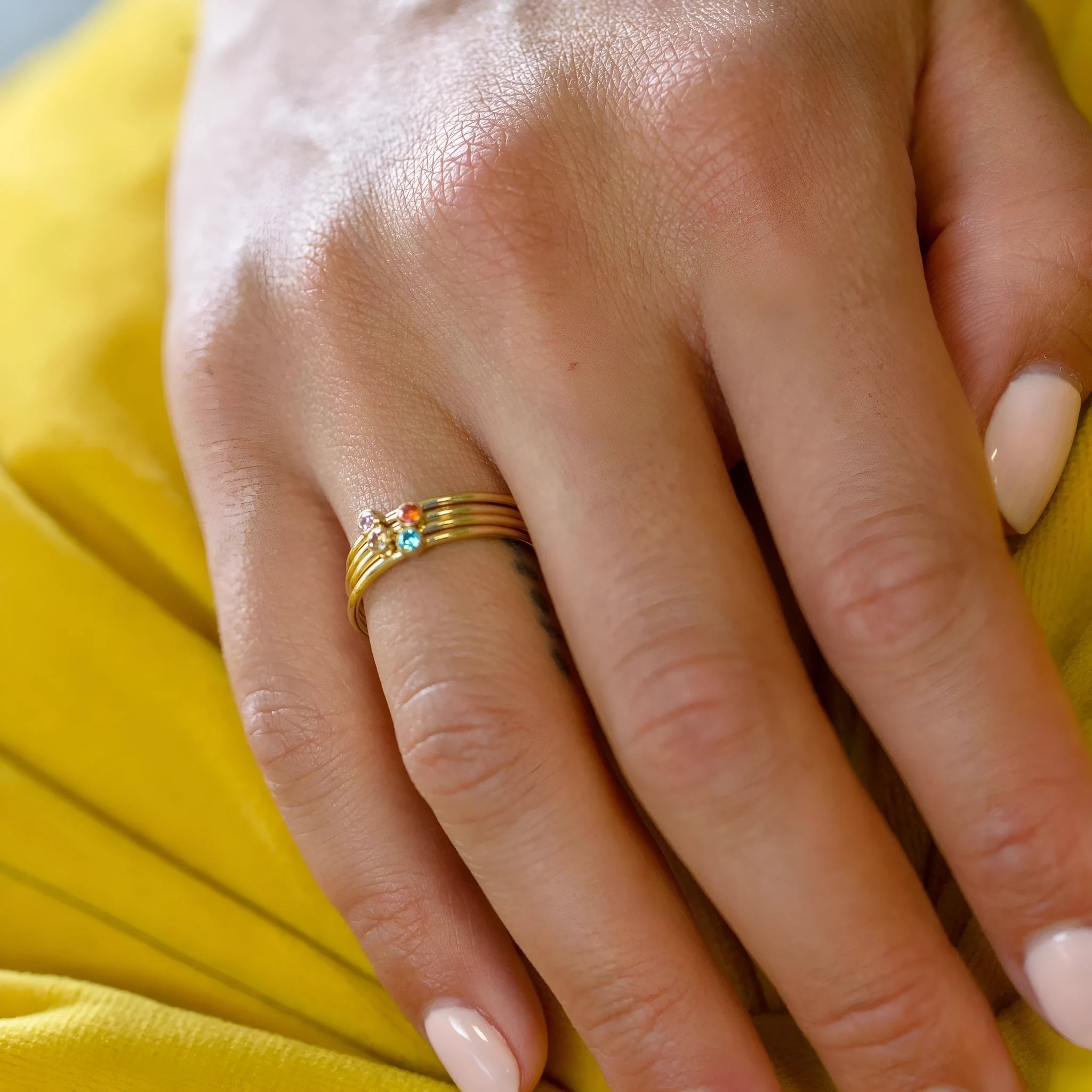 A geometric engraved titanium steel ring featuring a December birthstone in a superimposed design.