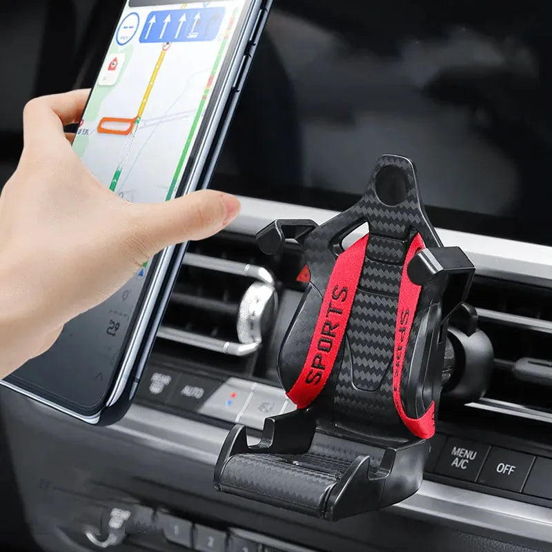Racing seat shape car phone holder clipped to a car air vent with a gold tape colour finish