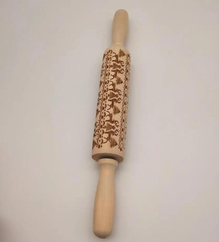 Natural wooden rolling pin with Christmas embossing patterns, 45 cm length, on a light background