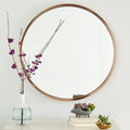 Round iron bathroom wall mirror in black finish, 30cm or 60cm diameter, hanging on a tiled wall for dressing and makeup use
