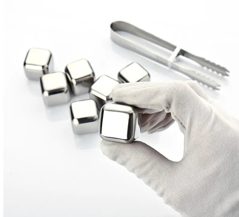 Set of 8 stainless steel ice cubes in square and ball shapes with plastic storage box and tong on a wooden surface