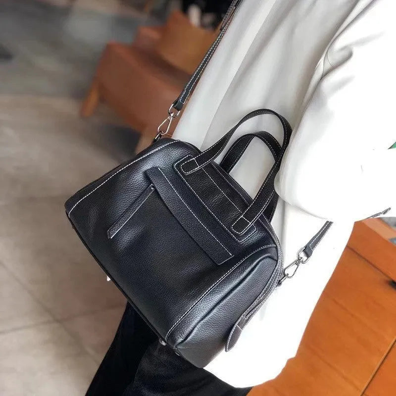 Genuine leather shoulder messenger bag with litchi pattern texture in a horizontal square shape.