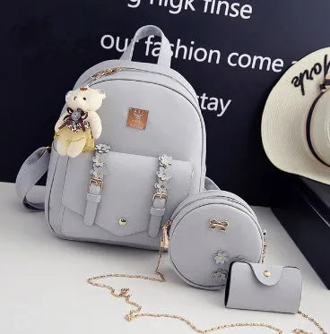 Three-piece women's bag set showing backpack, floral shoulder bag, and card holder in matching colour