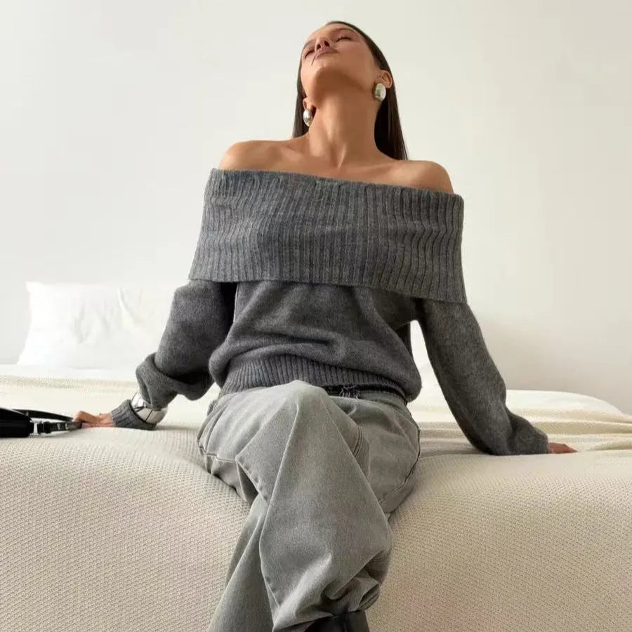 Grey off-the-shoulder acrylic sweater with a 3D pattern texture, modelled from the front.