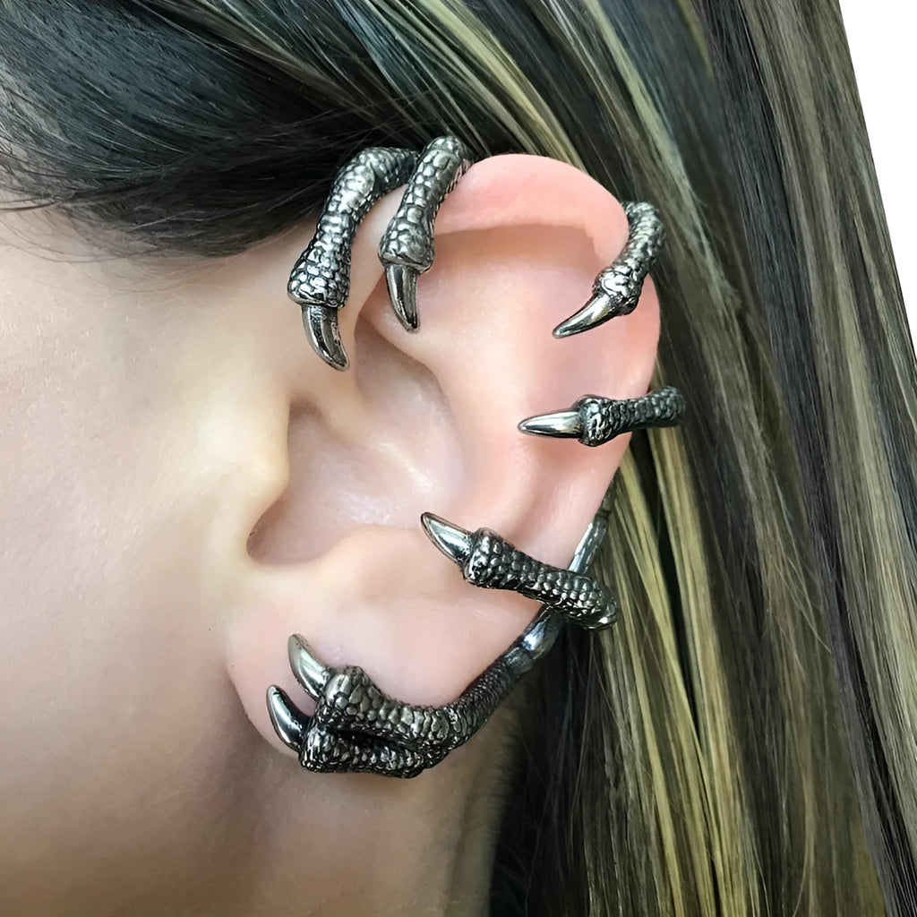 Black copper ear studs with street punk style electroplated finish on a plain background