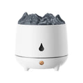 White volcano-shaped ultrasonic humidifier with USB cable on desk in a room