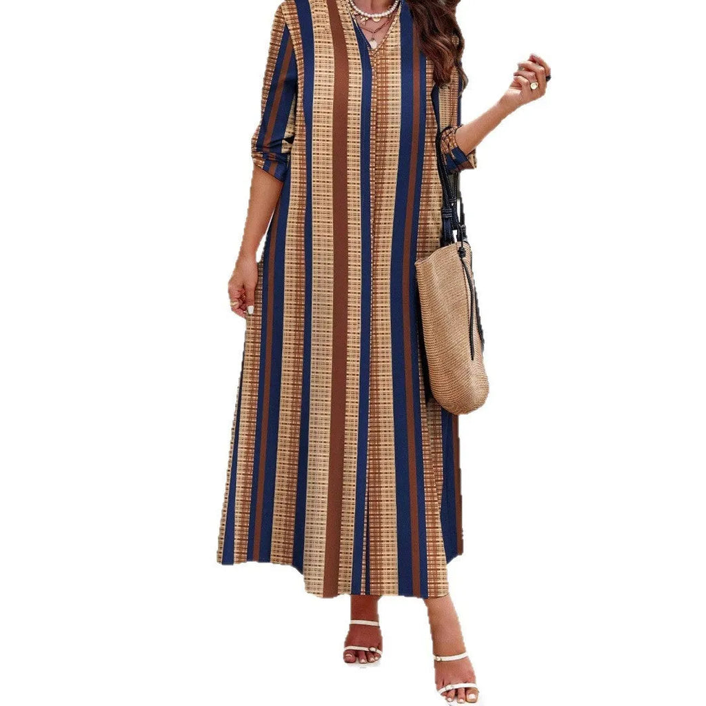 Camel coloured knitted polyester dress with vertical stripes, V-neck, long sleeves, and an A-line skirt.