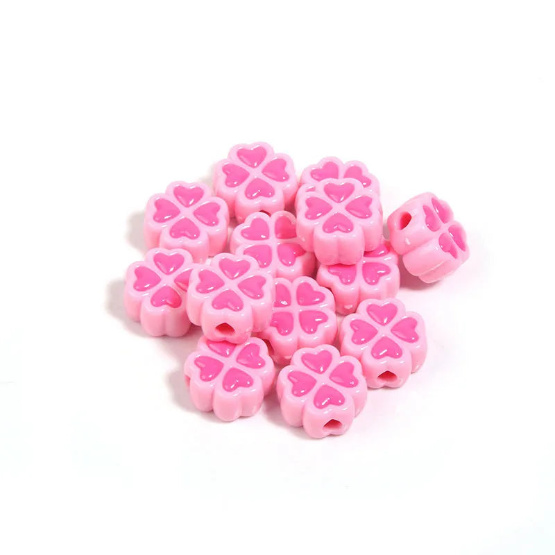 Acrylic four-leaf clover craft beads with love pattern in mixed colours showing frosted finish