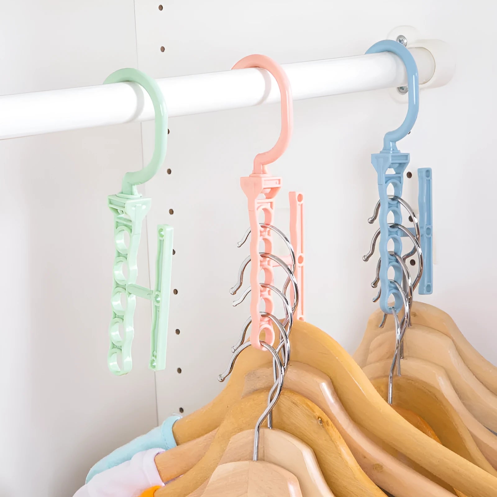 Blue revolving magic hanger with five branches and a handle for wardrobe organisation.