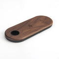 Wooden wireless charger with natural bamboo surface and walnut edging on a desk