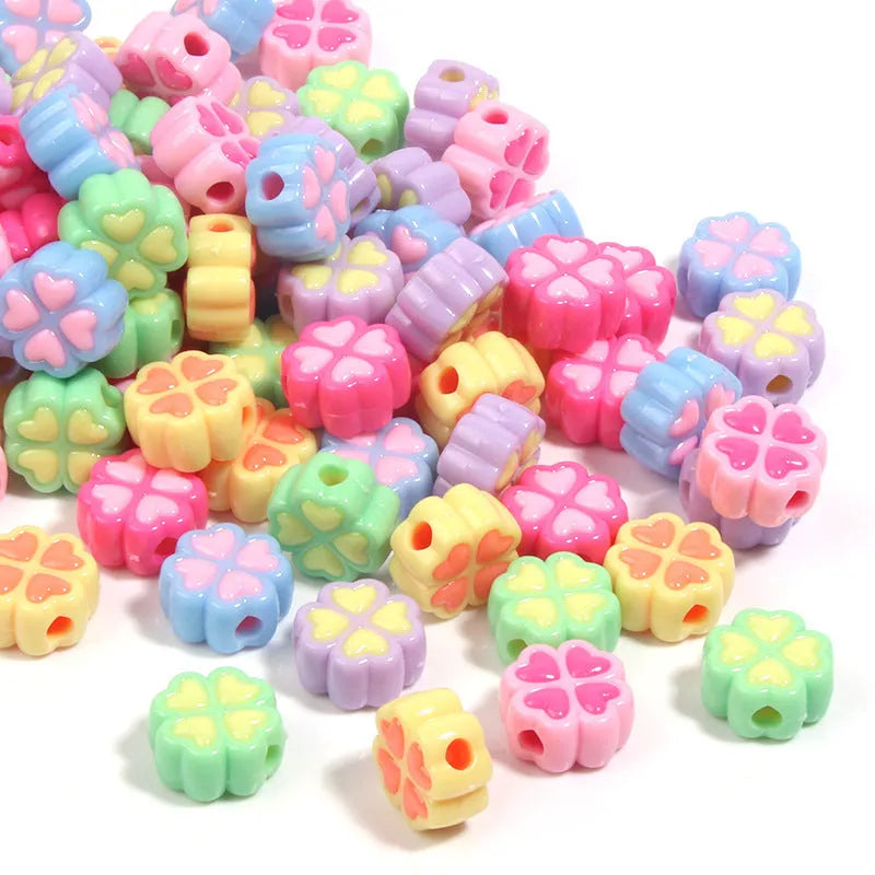 Acrylic four-leaf clover craft beads with love pattern in mixed colours showing frosted finish