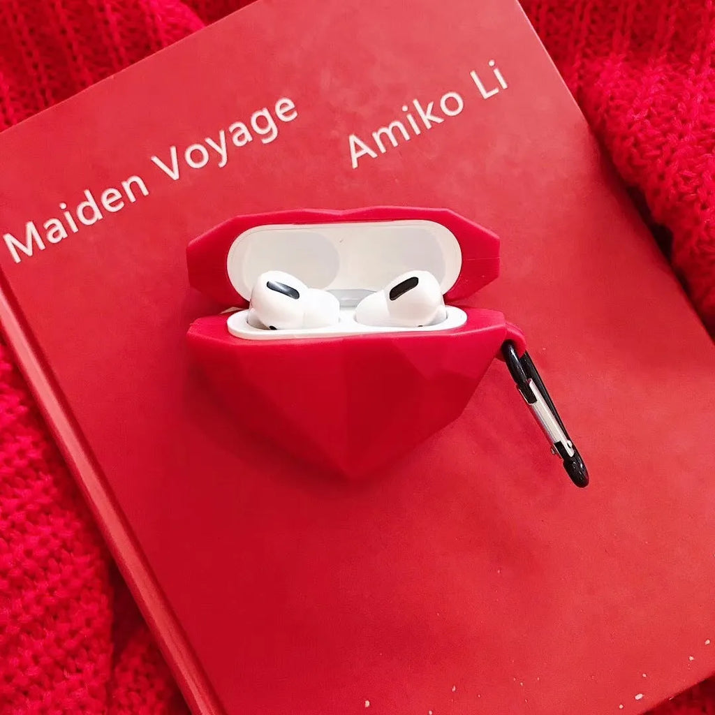 Red diamond love silicone case on Apple AirPods charging case with carabiner clip attached