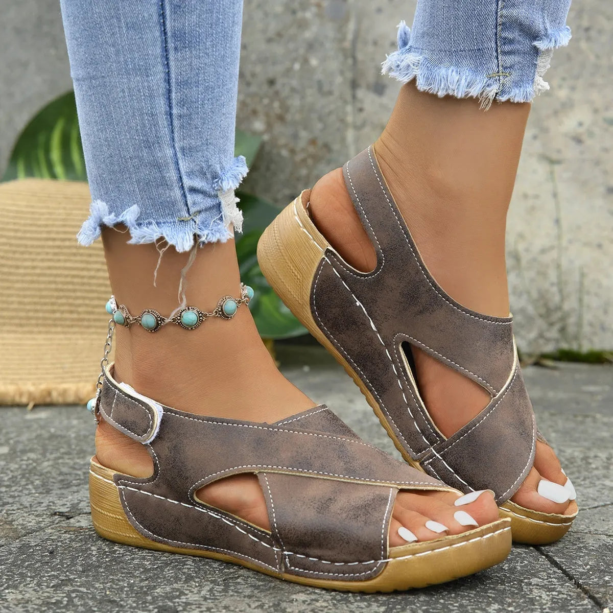 Women's brown platform Roman sandals with Velcro strap closure and open toe design