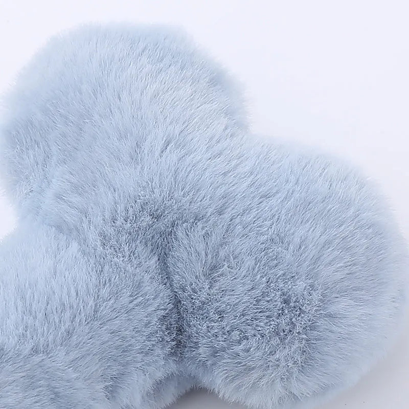 Blue pink and yellow plush bone dog toy with a textured grinding teeth surface.
