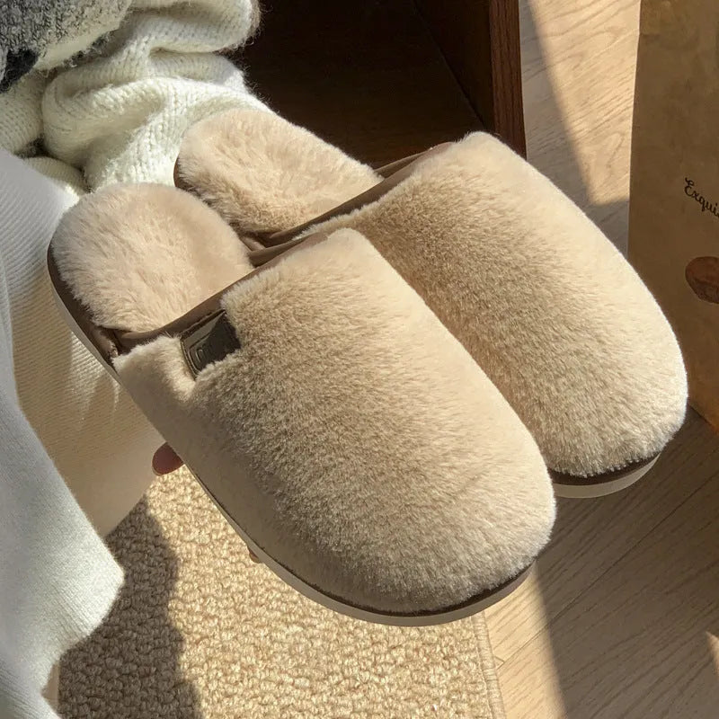 Solid colour winter plush slippers with non-slip PVC sole on a wooden floor.